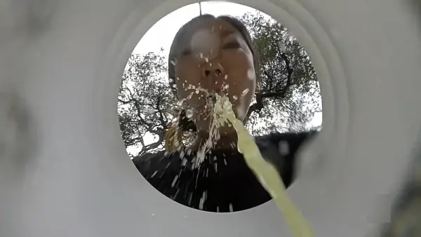 Girl feel sick and puking in a bucket outdoor