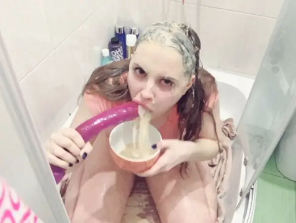 Girl gagging and puking in a cup and eating