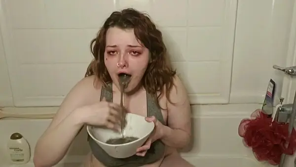 Pretty Girl puking in a bowl at home
